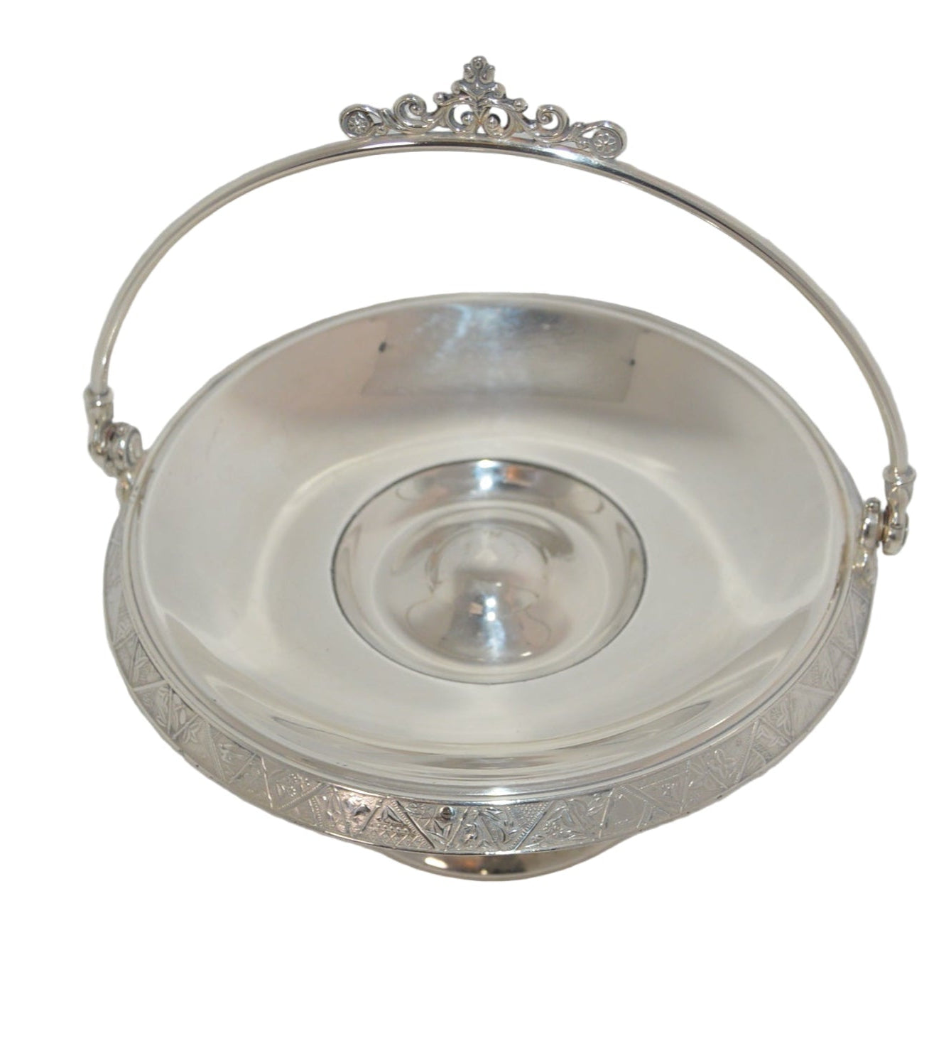 Vintage silver-plated candy dish early 1900's with handle and on pastel.