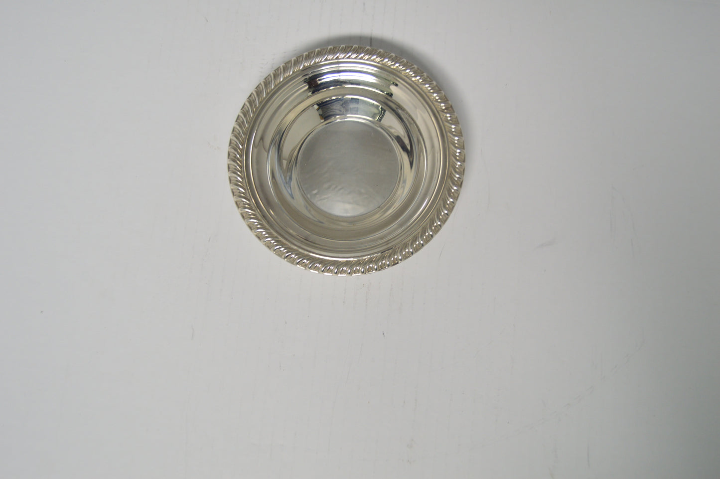 Silver-plated candy/nut dish measuring 6 1/2" wide and 1 1/2" deep excellent condition pre-owned
