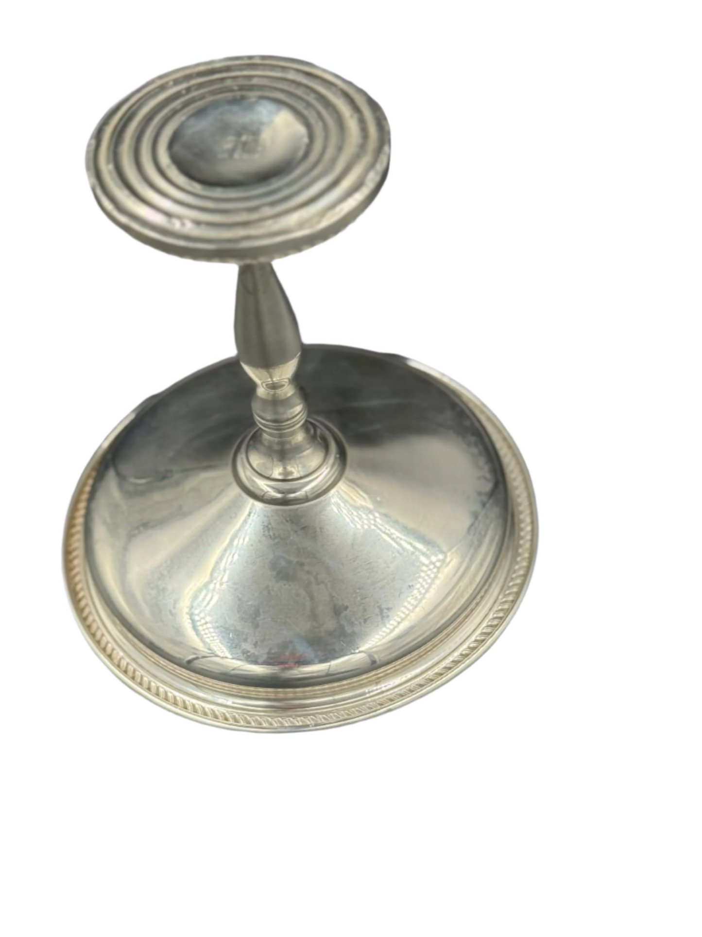 Silver candlestick holder on a dark gray background